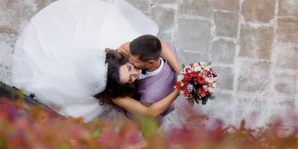 top view of beautiful wedding couple with wedding bouquet who ar